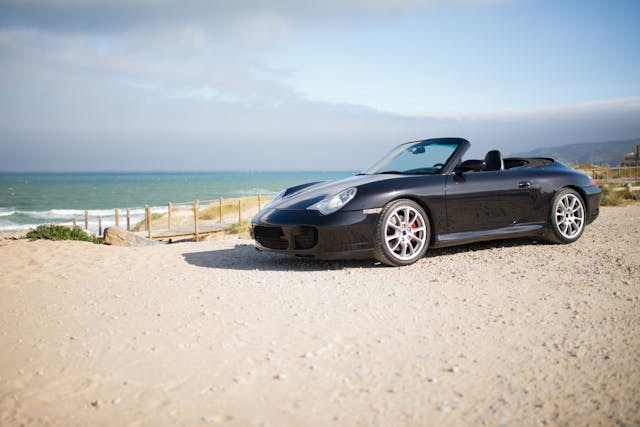 black convertible car on a beach