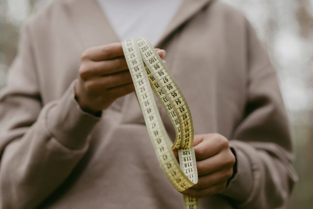 woman holding a tape measure
