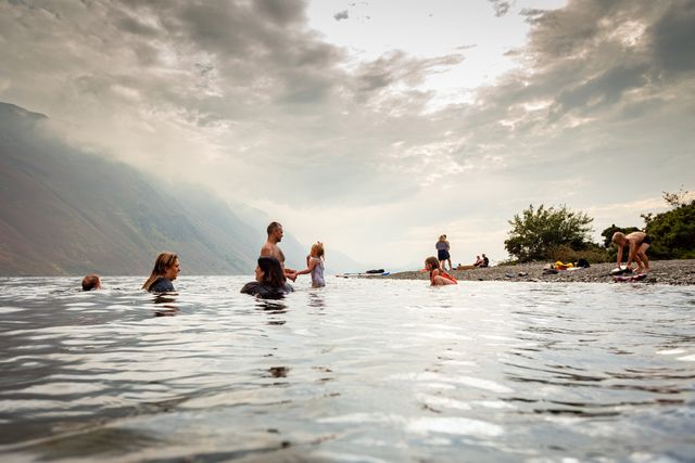 group of people wild swimming in an English lake